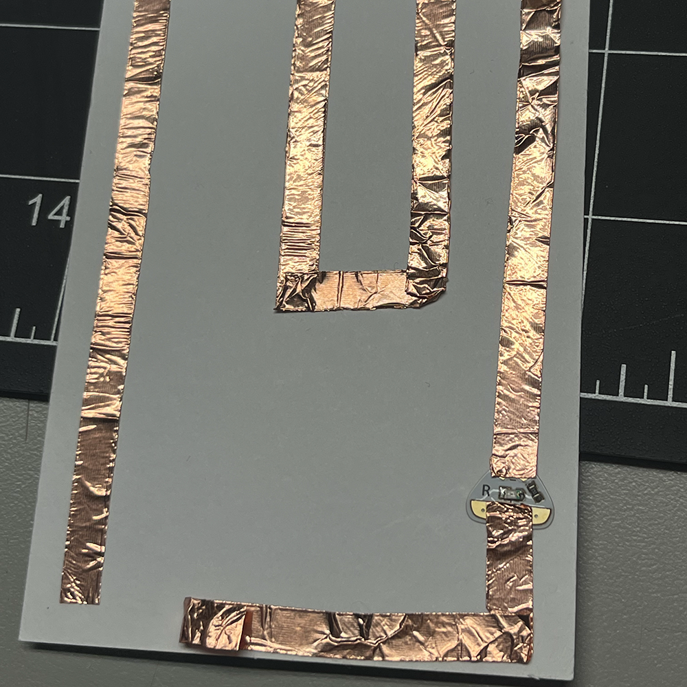 Making test of low voltage electricity through complex pathway using copper tap close in detail.